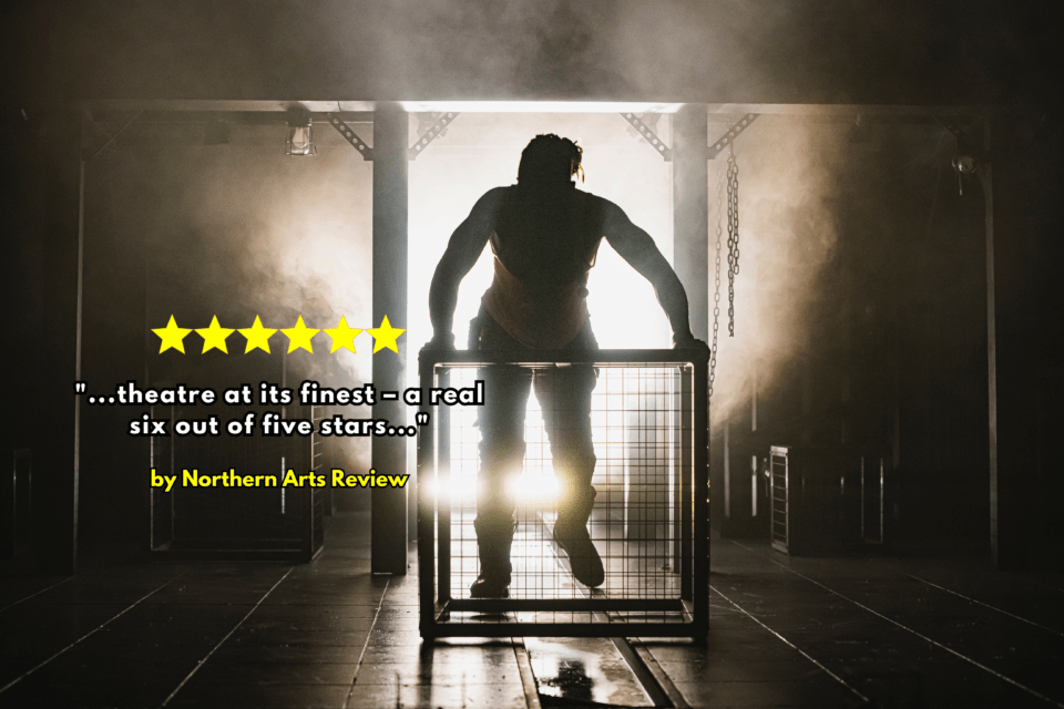 The silhouette of an actor in an insutrial looking set for Animal Farm