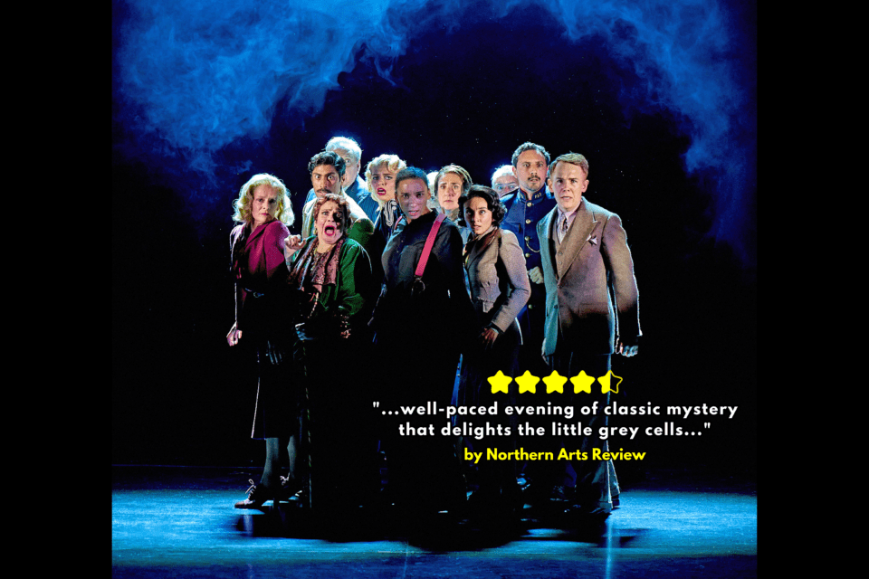 A group of actors stand on a stage under smoke for a production of Murder on the Orient Express