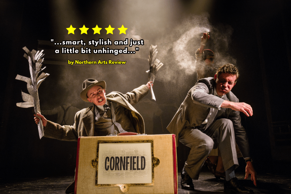 An actor holds up torn newspaper in front of a suitcase in the North by Northwest play