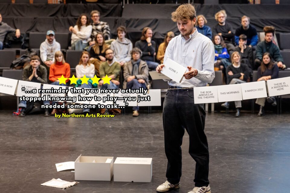 A man reads a card and places it on a string at Ontroerend Goed's Handle With Care