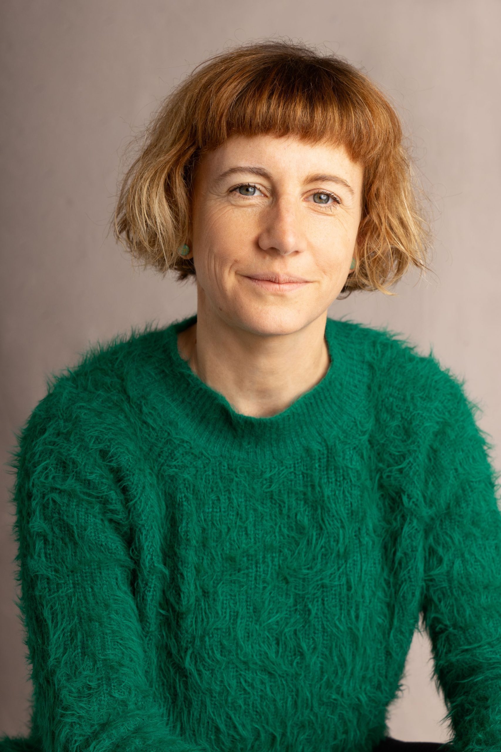 Northern Ballet dancer portraying Anne Lister lifts a leg in front of a table at Leeds Grand Theatre