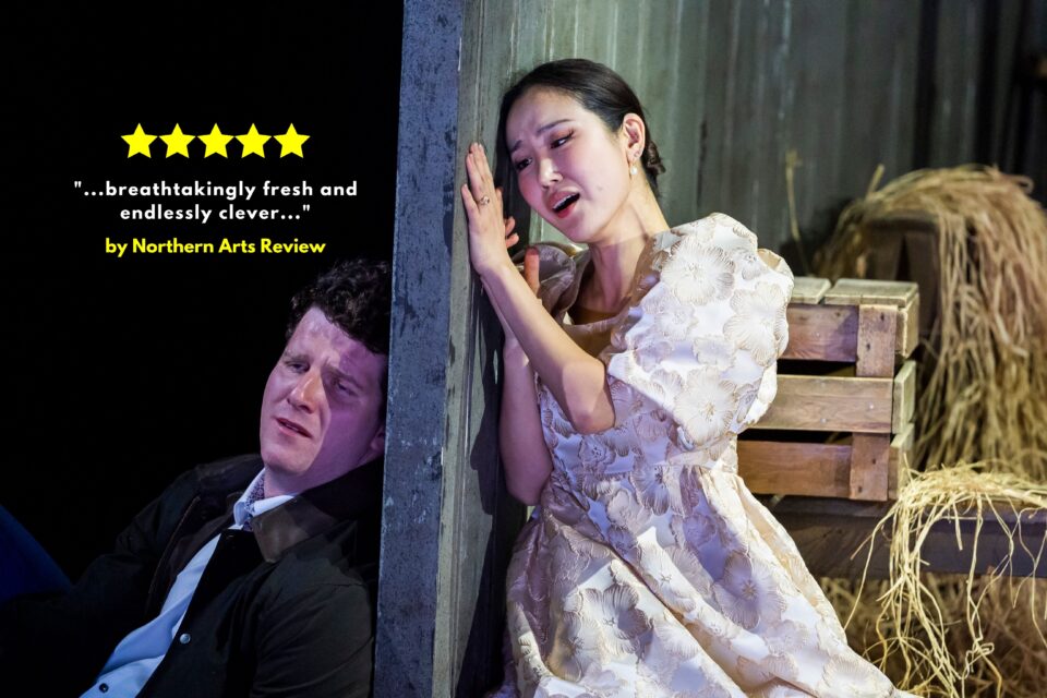 Figaro sits on one side of a stable wall, in anguish as Susanna sings from the other side in The Marriage of Figaro